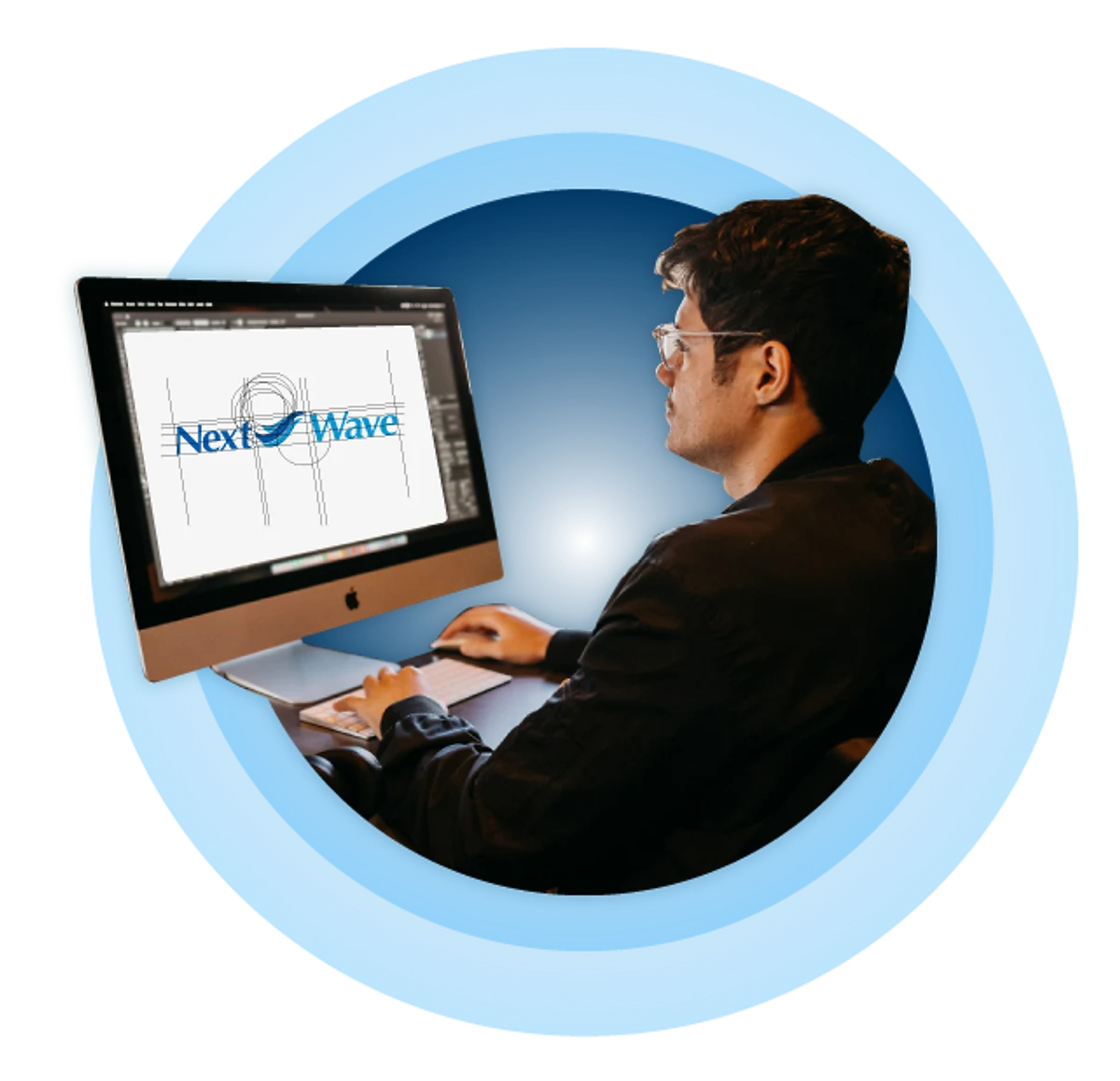 Man working at a desktop computer showing Next Wave logo