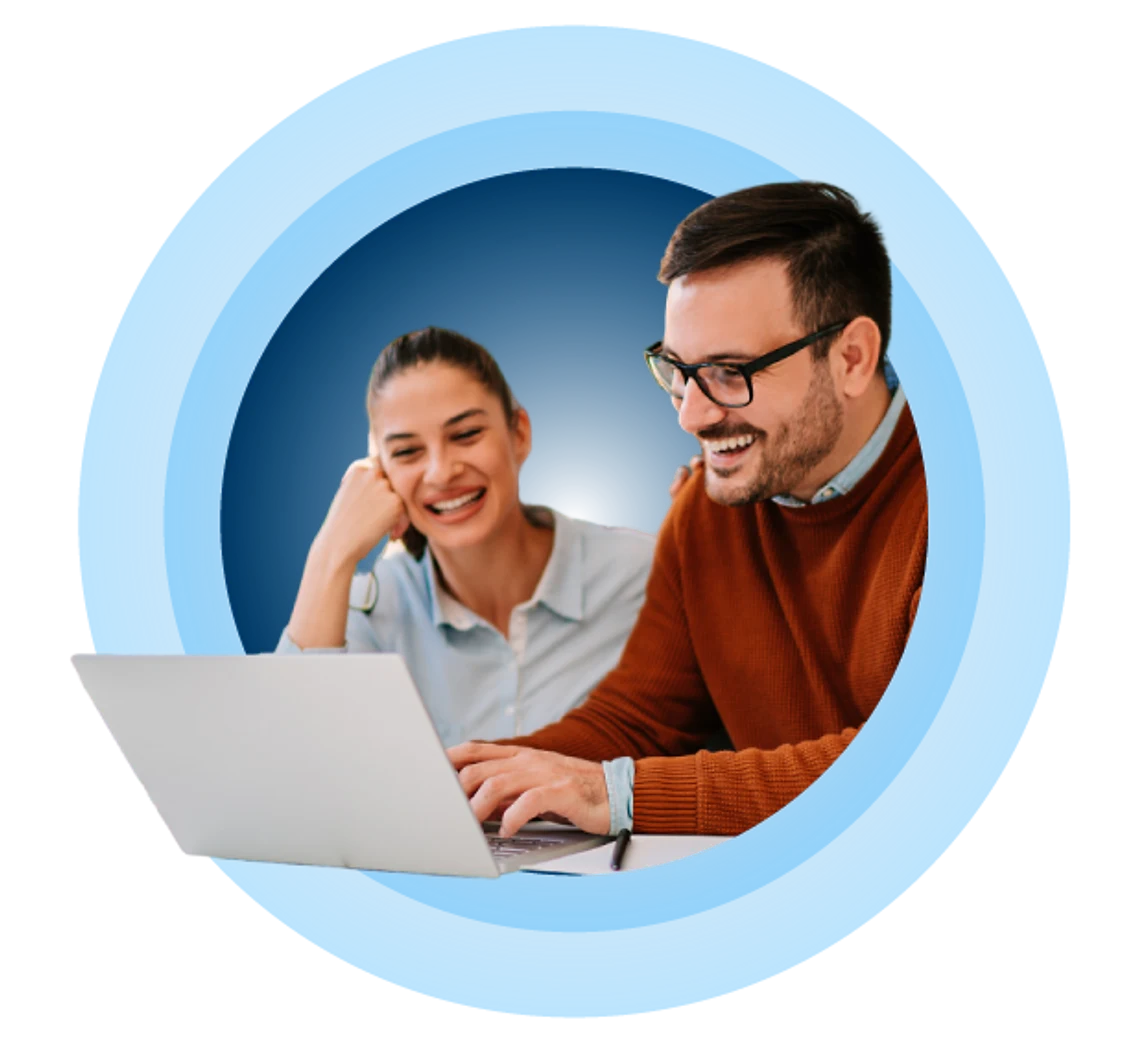 Smiling colleagues working together on a laptop
